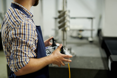 Factory Worker Holding Control Panel Closeup