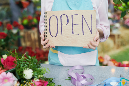 Florist Holding OPEN Signの写真素材