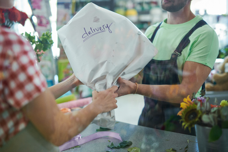 Delivery Man Giving Bouquetの写真素材