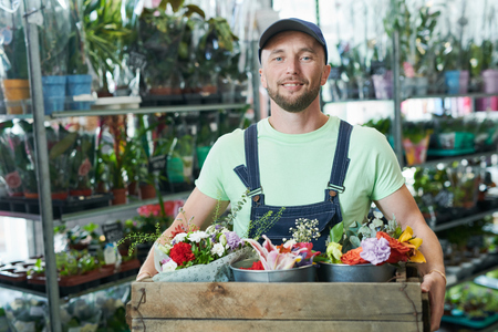 Man holding box with flowersの写真素材