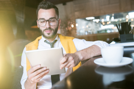 Businessman Using Tablet in Sunlightの写真素材