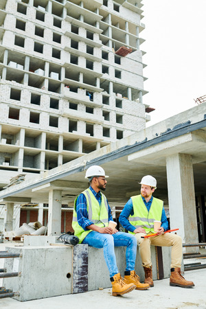 Multiethnic engineers having break at construction siteの写真素材