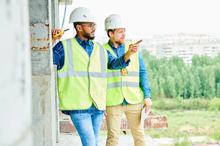 Workers discussing location of modern buildingの写真素材