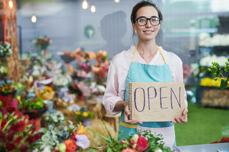 Shopkeeper Holding OPEN Signの写真素材