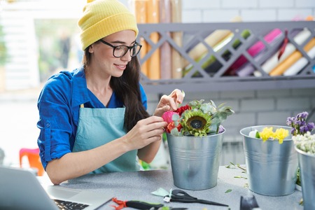 Creative Woman Arranging Flowersの写真素材