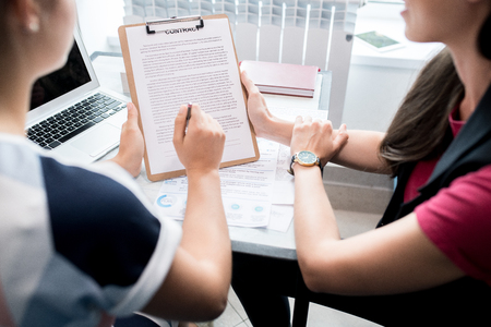 Business People Discussing Contract Closeupの写真素材