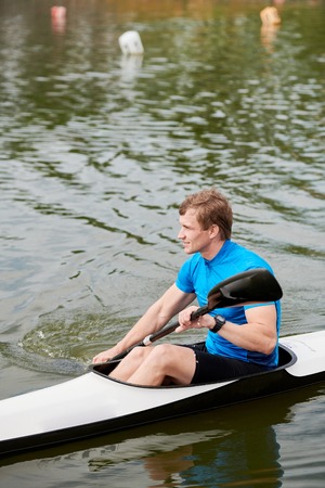 Man training on the lakeの写真素材