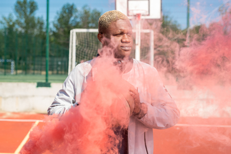 African Basketball Player in Red Smokeの写真素材