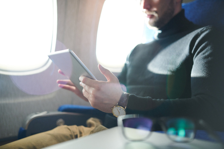 Man Using Tablet in Airplaneの写真素材