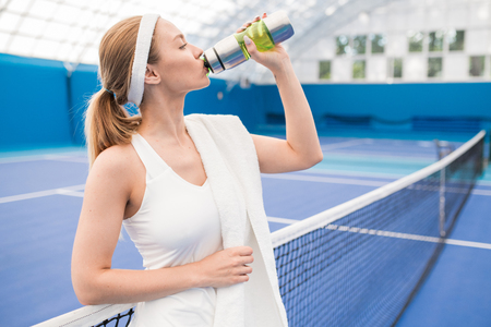 Young Woman Refreshing after Practiceの写真素材