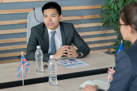 Asian politician discussing budgeting issues with colleagueの写真素材