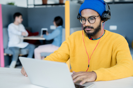 Serious middle-eastern man working with laptopの写真素材