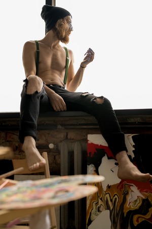 Pensive Artist Smoking on Windowの写真素材