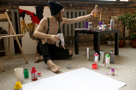 Artist Spray Painting on Floorの写真素材