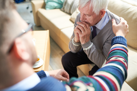 Psychiatrist consoling elderly patientの写真素材