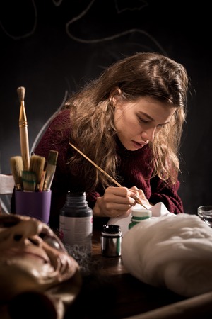Mask-maker working on design of Halloween maskの写真素材