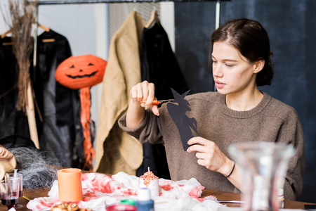 Creative lady cutting up witchの写真素材