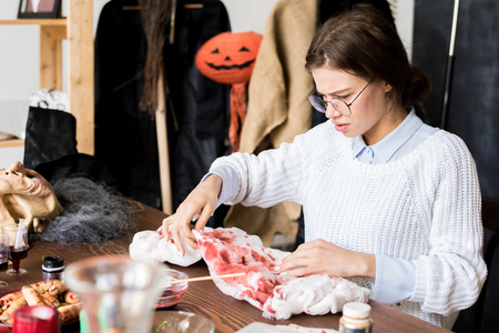Making bloody stains on Halloween costumeの写真素材