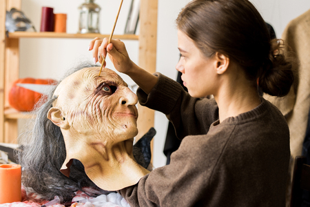 Serious woman concentrated on mask-makingの写真素材