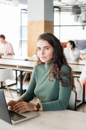 Confident attractive woman preparing report in officeの写真素材