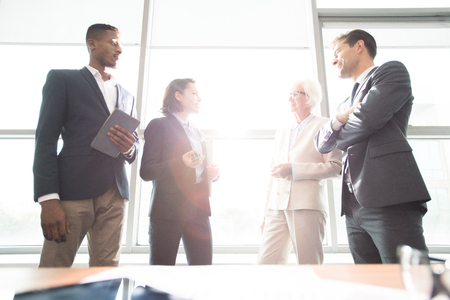 Confident business people discussing plans in officeの写真素材