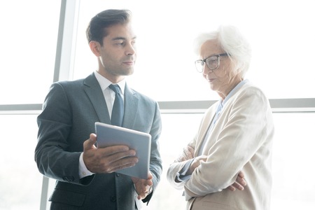 Thoughtful business analysts browsing internetの写真素材