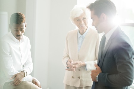 Positive business managers discussing plans at briefingの写真素材