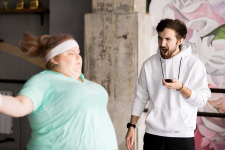 Angry Coach Training Obese Womanの写真素材