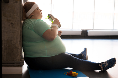 Obese Woman Drinking Waterの写真素材