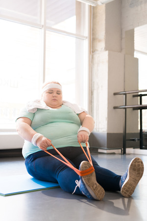 Overweight Woman Training in Fitness Classの写真素材