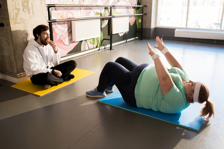 Obese Woman Working Out on Floorの写真素材