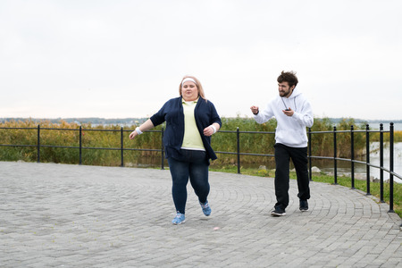 Overweight Woman Running Outdoorsの写真素材