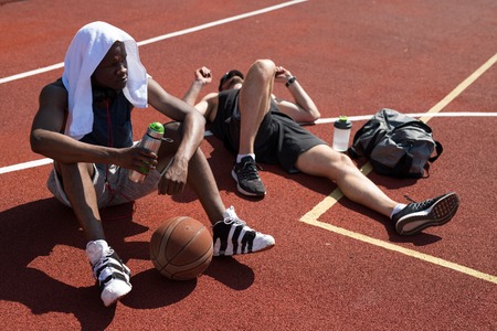Two Basketball Players Relaxing in Courtの写真素材