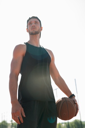 Handsome Basketball Player Posing Outdoorsの写真素材