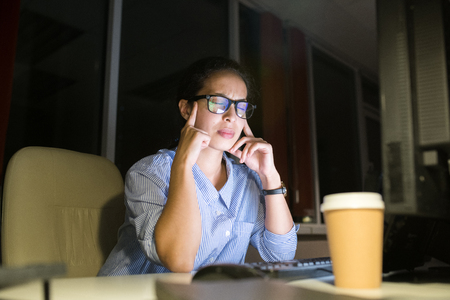 Stressed Woman Working at Nightの写真素材