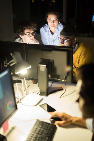 Group of Colleagues Working at Nightの写真素材