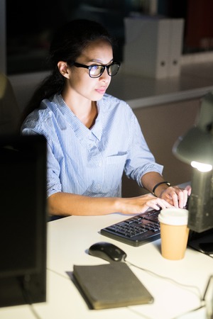 Young Woman Working at Nightの写真素材