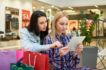 Pretty girls searching for information about black Fridayの写真素材