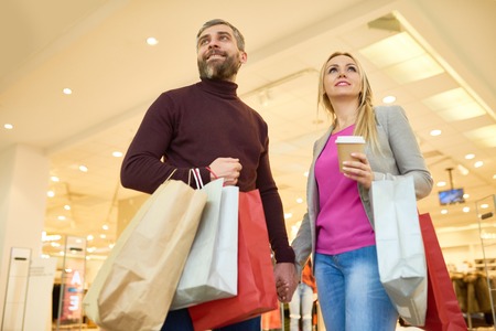 Happy Couple Looking at Displays in Mallの写真素材