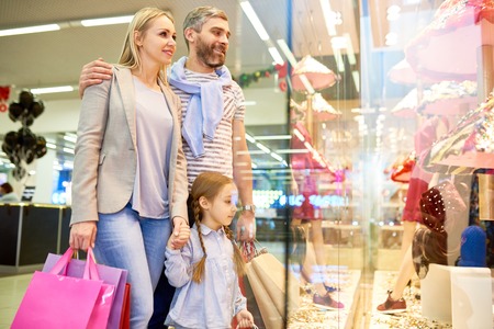 Family Choosing Kids Clothes in Mallの写真素材