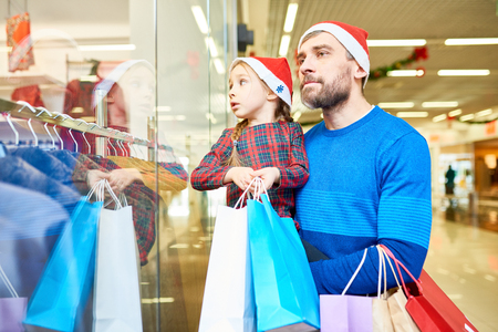 Man with daughter shopping in Christmas timeの写真素材