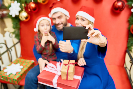 Family taking selfie while celebrating Christmasの写真素材
