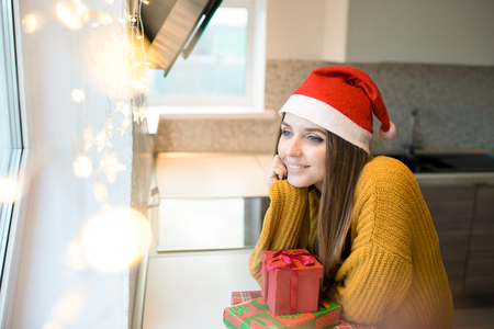 Dreamy woman with holiday presentsの写真素材