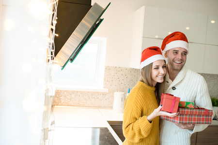Happy man and woman with Christmas presentsの写真素材