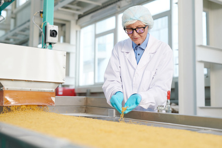 Senior Woman at Production Line