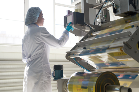 Woman Operating Packaging Machineの写真素材