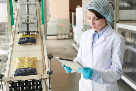 Young  Woman at Packaging Lineの写真素材