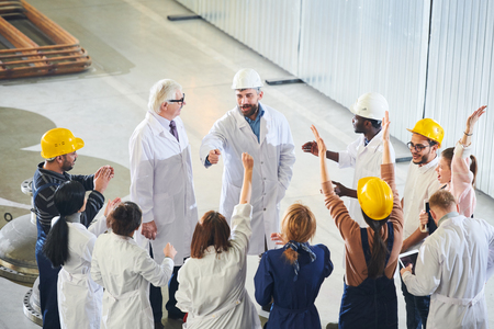 Factory Managers Talking to Workersの写真素材