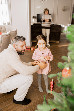 Little Girl Decorating Christmas Treeの写真素材