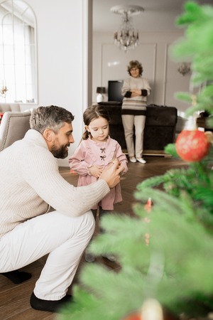 Father Decorating Christmas Treeの写真素材